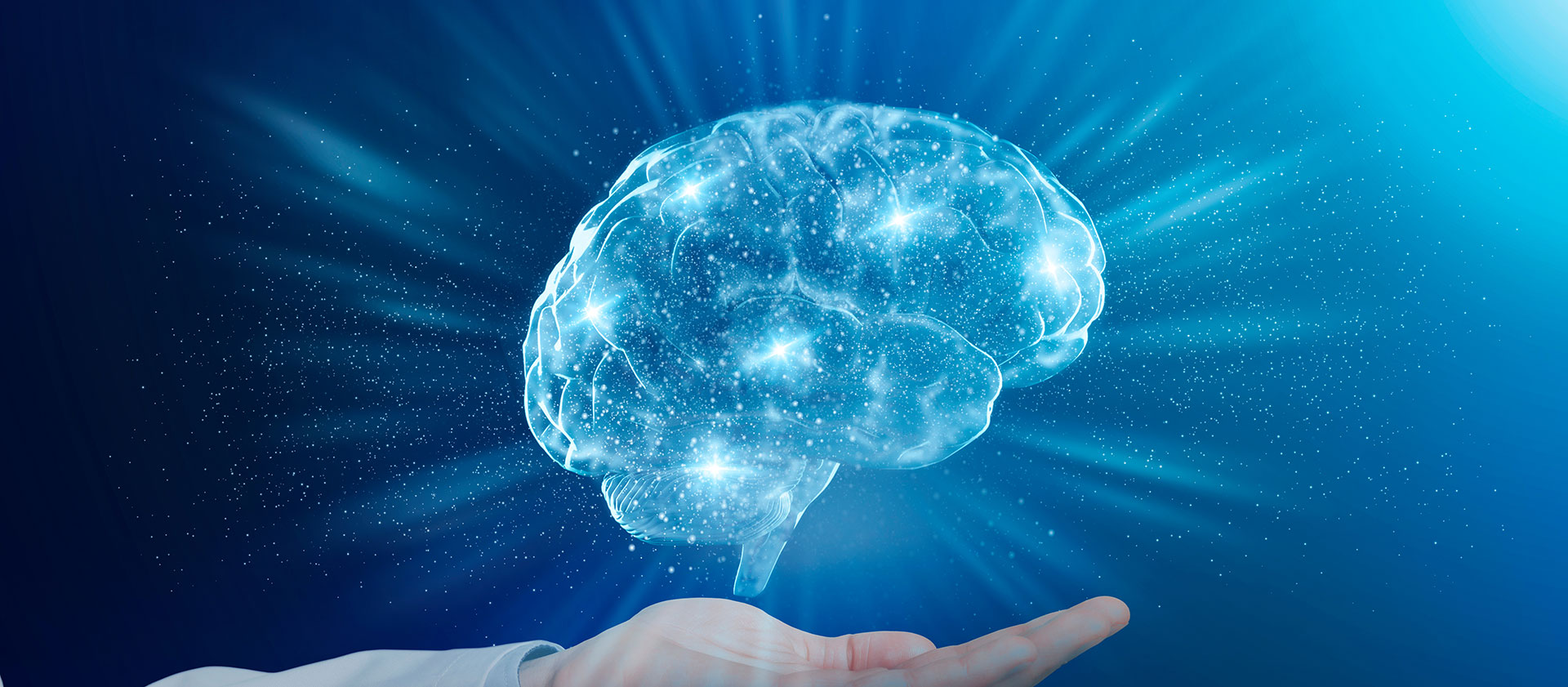 The image depicts a human hand holding a transparent sphere filled with glowing blue brain cells, symbolizing intelligence or cognitive processes, set against a cosmic background with stars.