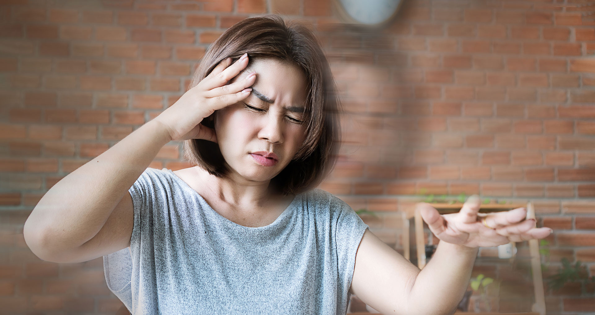 A woman with her hand on her head, seemingly in a state of confusion or stress.